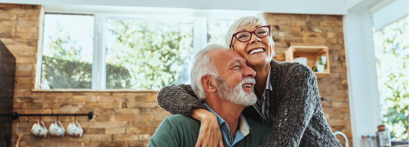 older couple embracing in a modern kitchen